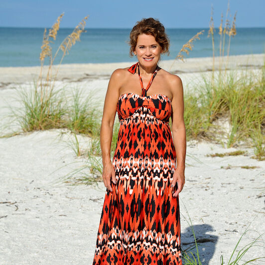 Beautiful Mature Woman Wearing a Sundress on the Beach